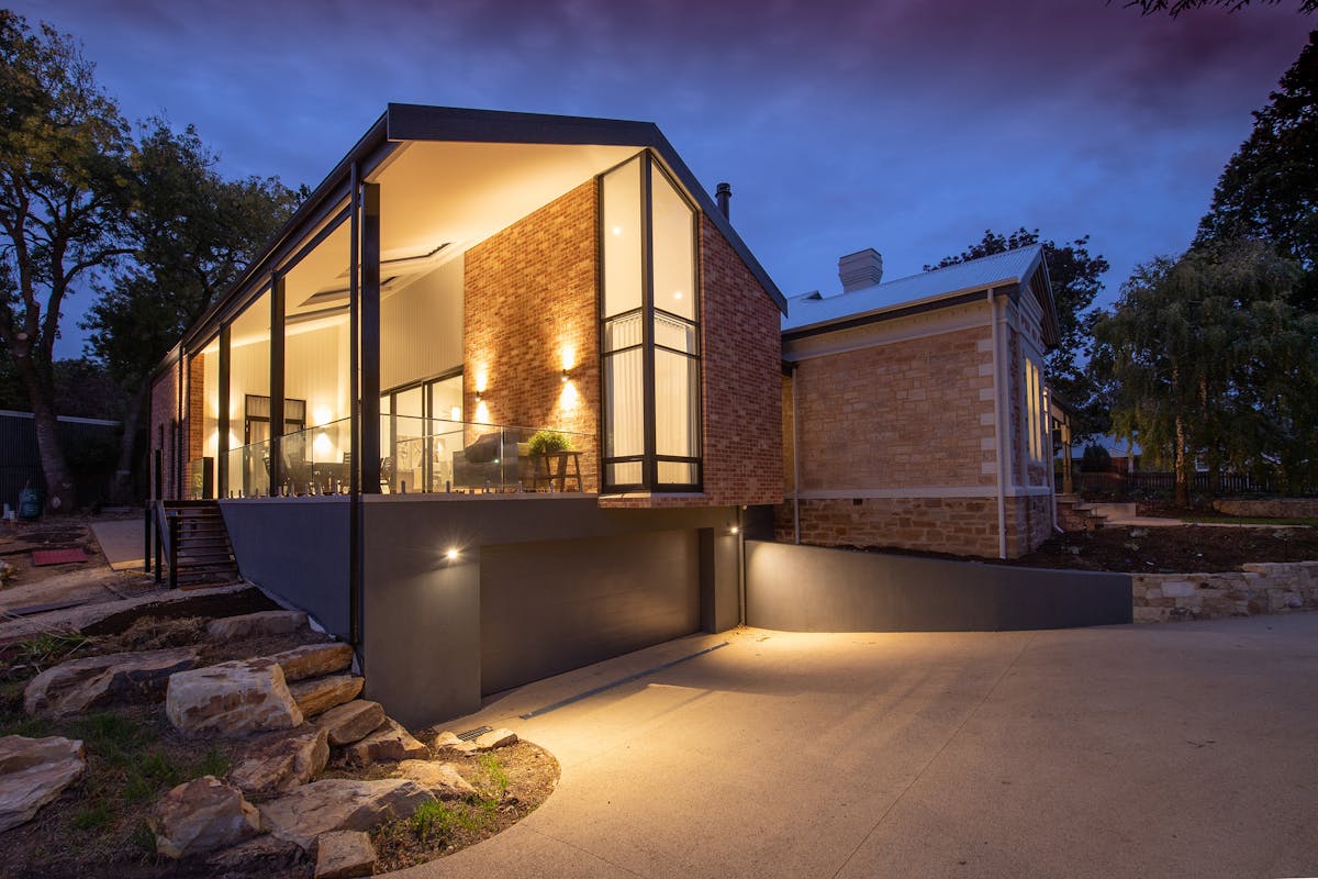 House facade with glowing lights at dusk